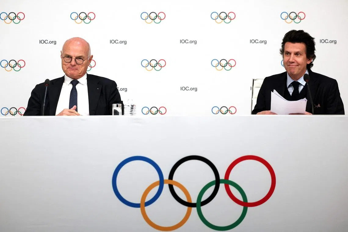 IOC member and Advisory Board Member Karl Stoss of Austria (left) and Olympic Games Executive Director Christophe Dubi at a press conference after an IOC Executive Board committee meeting in Paris.