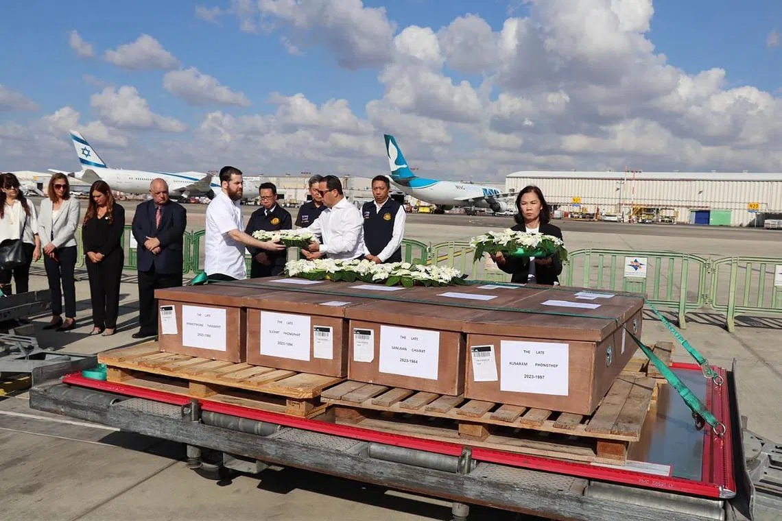 hylabour - Ms Pannabha Chandraramya, Ambassador of Thailand to Israel, lays wreaths on the coffins of Thai workers killed in Israel at Ben-Gurion Airport, Tel Aviv, on 19 October 2023, before they are sent to Thailand..



Byline: Ministry of Foreign Affairs, Thailand
