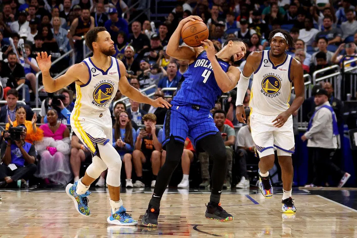 ORLANDO, FLORIDA - NOVEMBER 03: Stephen Curry of the Golden State Warriors fouling Orlando Magic guard Jalen Suggs (No. 4) in their NBA clash at Amway Centre on Thursday. Magic narrowly beat the Warriors 130-129.
