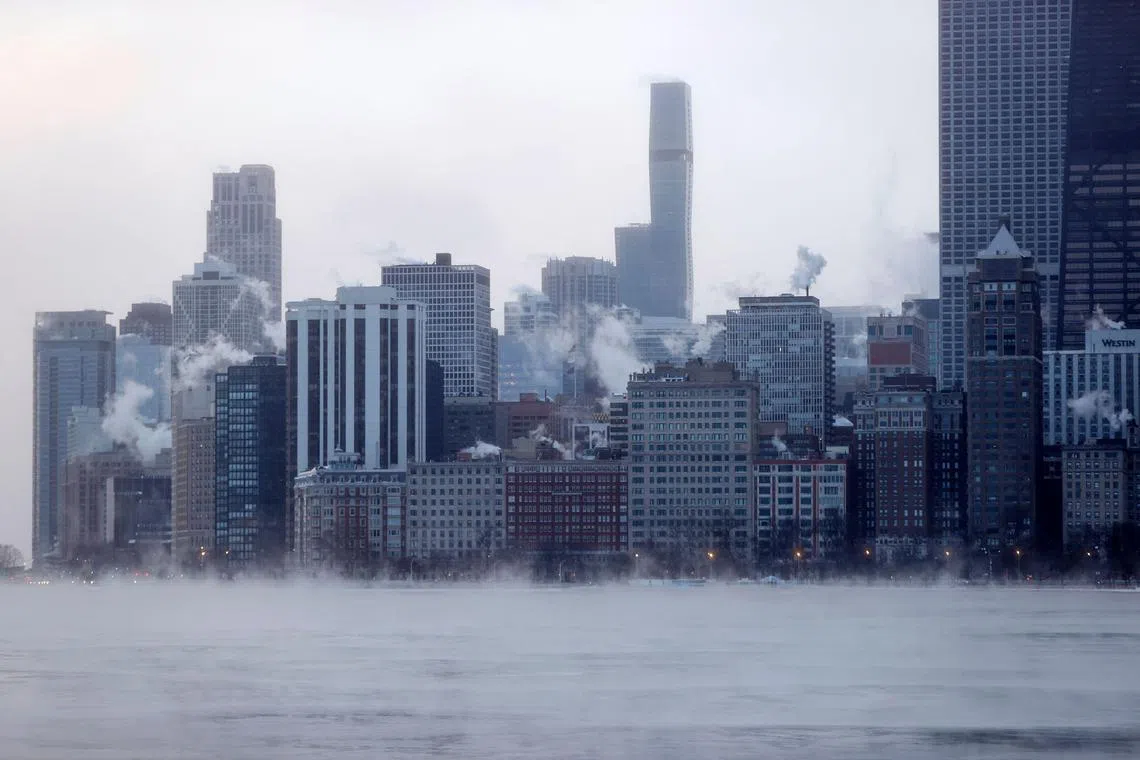 Mist rises from Chicago and Lake Michigan at sunrise on Dec 23, 2022, where temperatures reached -21 deg C. 