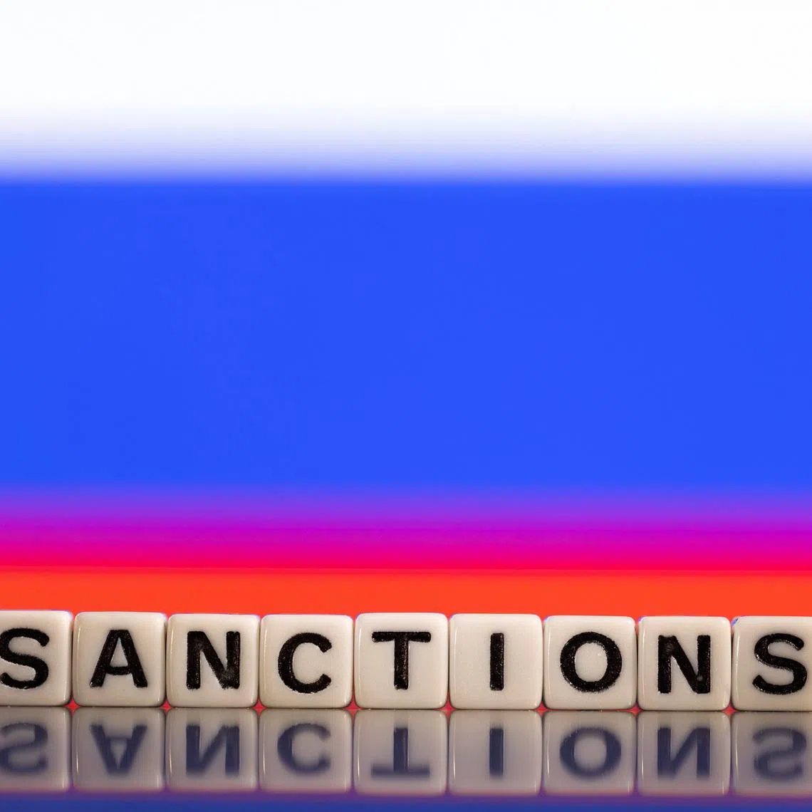 Plastic letters arranged to read \"Sanctions\" are placed in front of Russian flag colors in this illustration taken February 25, 2022. REUTERS/Dado Ruvic/Illustration