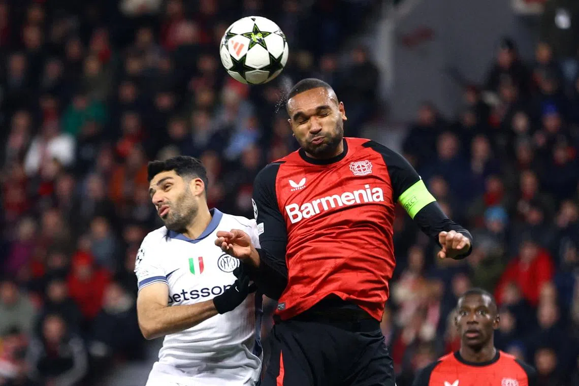 FILE PHOTO: Soccer Football - Champions League - Bayer Leverkusen v Inter Milan - BayArena, Leverkusen, Germany - December 10, 2024 Bayer Leverkusen's Jonathan Tah in action with Inter Milan's Mehdi Taremi REUTERS/Thilo Schmuelgen/File Photo