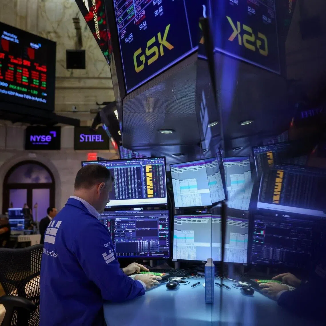 A trader works on the floor at the New York Stock Exchange in New York.