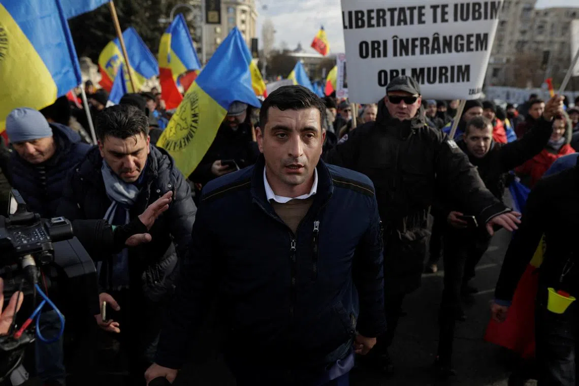 George Simion, co-leader of Alliance for the Union of Romanians (AUR) party, leads a group of protesters in an attempt to enter the Romanian Parliament building during a protest against the introduction of COVID passes, in Bucharest, Romania, December 21, 2021. Inquam Photos/George Calin via REUTERS/ File Photo