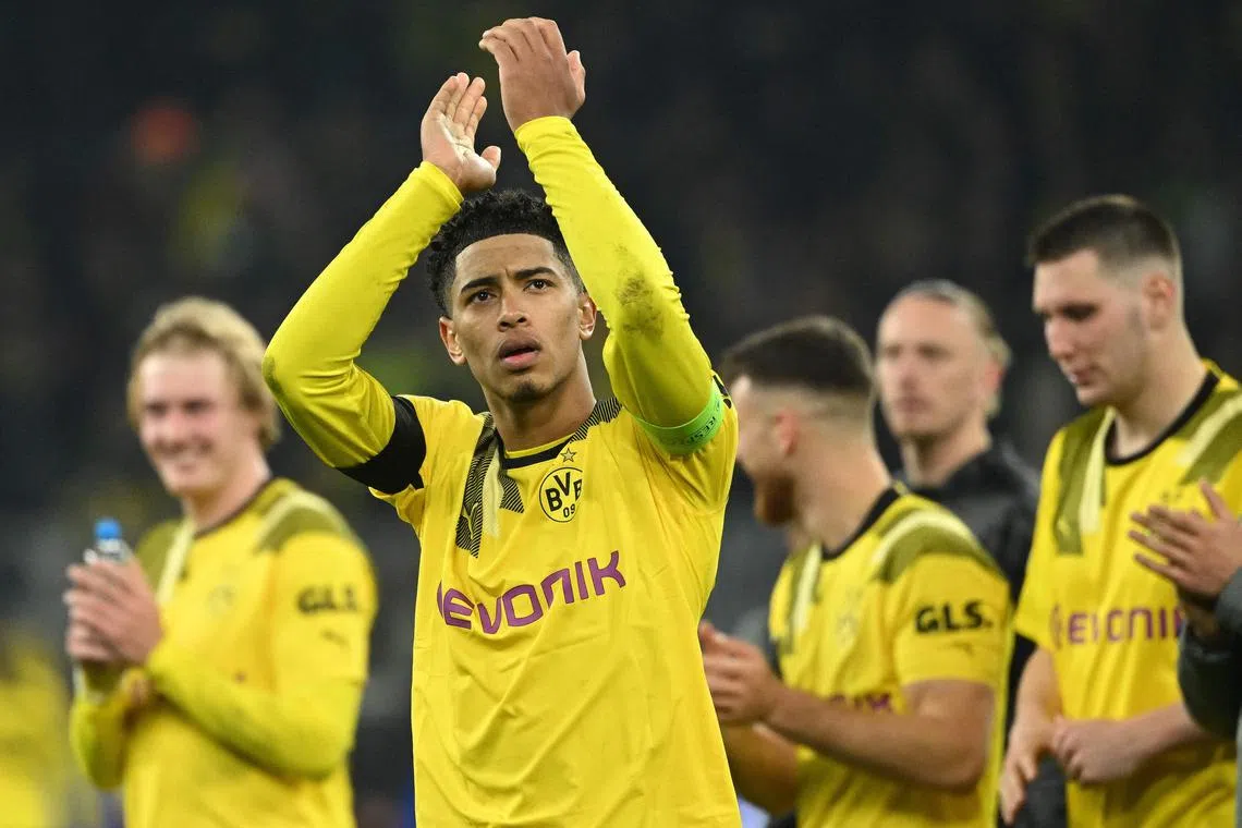 Dortmund players including English midfielder Jude Bellingham (centre) applaud fans after the match.
