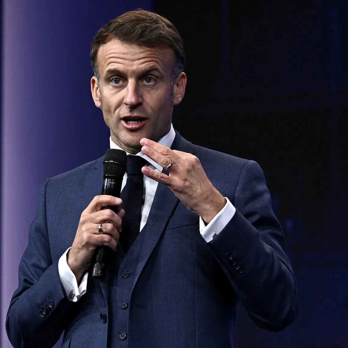 France's President Emmanuel Macron gestures as he speaks during the opening of the \"Adopt AI\" international summit on artificial intelligence, at the Grand Palais in Paris, France November 25, 2025. Julien De Rosa/Pool via REUTERS
