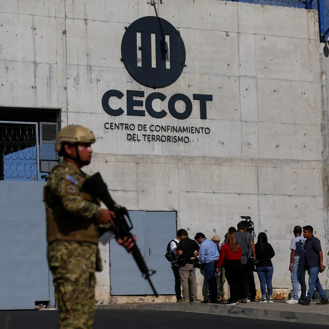 A Salvadoran soldier stands guard, as the CECOT logo is seen, during a media tour at the Terrorism Confinement Center (CECOT) prison, in Tecoluca, El Salvador April 4, 2025. REUTERS/Jose Cabezas