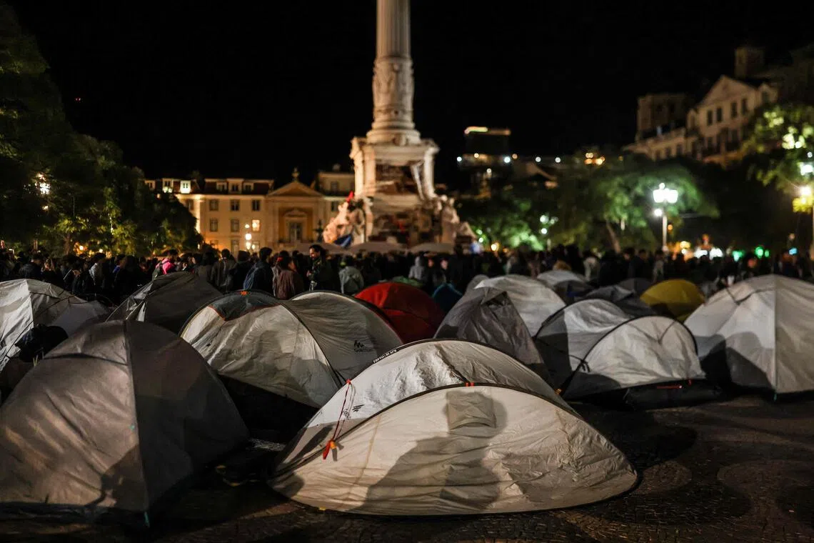 An encampment set up in protest against housing shortages, soaring rents and low wages, at Rossio square in central Lisbon late on Oct 19.