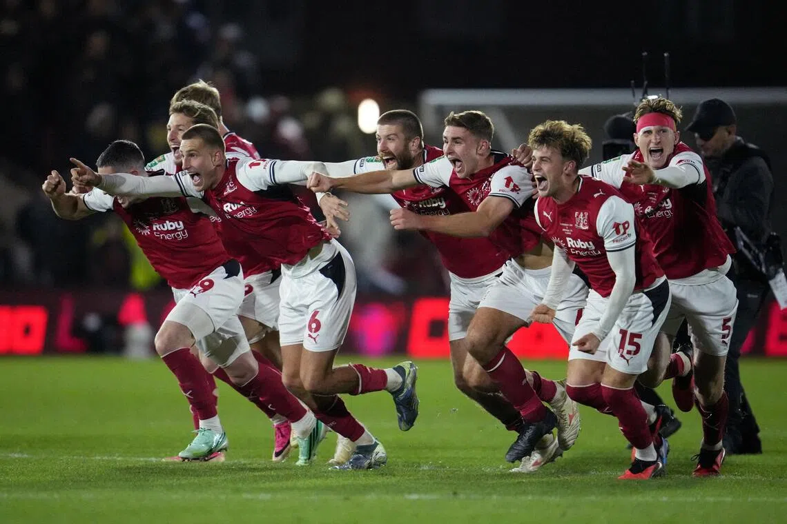 Fleetwood Town’s Rhys Bennett and his teammates celebrate winning the penalty shootout against Arsenal on Oct 27.