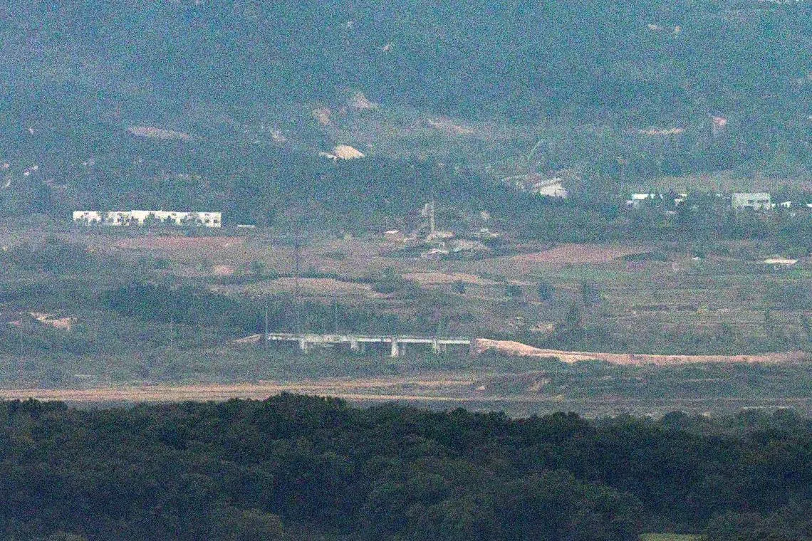 A mound of dirt is piled up near a structure on the road of the Gyeongui Line in the northern area of the Demilitarized Zone (DMZ), separating the two Koreas, in this picture taken from Paju, South Korea, October 14, 2024. Yonhap/via REUTERS