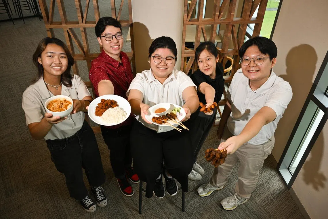 ST20230315-202370764349-Lim Yaohui-Josiah Teo-jtmeat15/
(From left) Cheryl Pow, 20; Jacob Ang, 20; Kathleen Tay, 21; Annabel Teo, 20; and Benedict Lim, 20; all final year Temasek Polytechnic students taking diploma in food, nutrition, and culinary science, with their dishes at Bistro Lab in Temasek Polytechnic on Mar 15, 2023.
Temasek Polytechnic students, research scientists and lecturers, together with Japanese food tech giant Fuji Oil have created Singapore's plant-based versions of local hawker delights. The No-MOO Satay (Vegan Beef satay), No-CLUCK Satay (Vegan Chicken satay), Wow-gyu Rendang (Vegan Beef Rendang) and Shojin Laksa (Vegan Laksa) are the polytechnic's first endeavour into meat-free options developed as a student project.
Using Fuji Oil's textured vegetable protein (TVP), high moisture meat analogue (HMMA) and other ingredients, the team was able to recreate the "meat-less" dishes without compromising on the traditional taste that Singaporeans are familiar with. Combining food tech and local aromatic spices, including Fuji Oil's proprietary ingredients utilising MIRACORE(tm) technologies to bring out the inherent flavours of the dishes, the outcome proves that the combination of tech and food science need not sacrifice taste and texture, an important addition to Singapore's sustainable food options.
The project not only resulted in delicious meat-free options for Singapore, but Fuji Oil Singapore will also hire 2 graduating students from the Diploma in Food Science & Nutrition who worked on this as their final-year project.
(ST PHOTO: LIM YAOHUI)