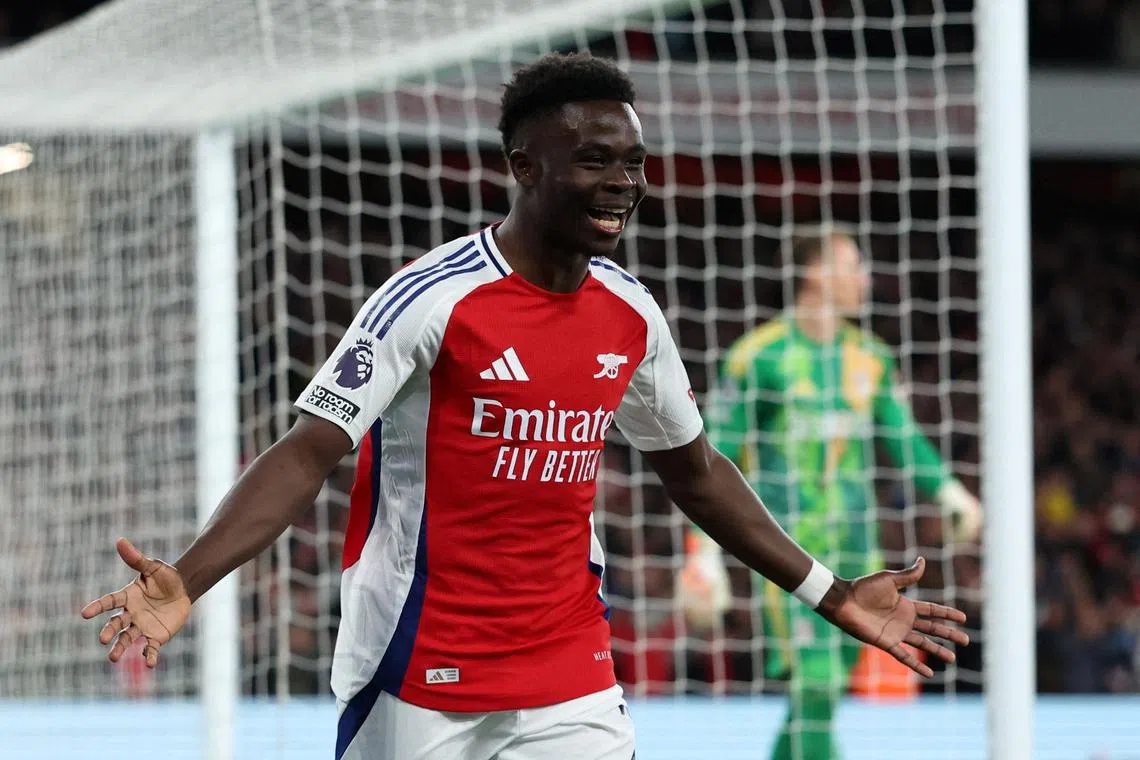 Arsenal's Bukayo Saka celebrates scoring against Fulham at the Emirates Stadium.