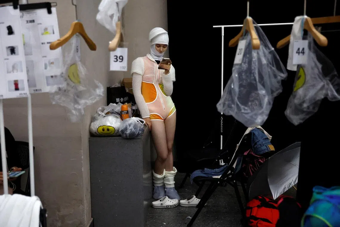 A model waiting backstage at the D.MARTINA QUEEN Spring/Summer 2024 collection show by Ding Jie on Sept 9.