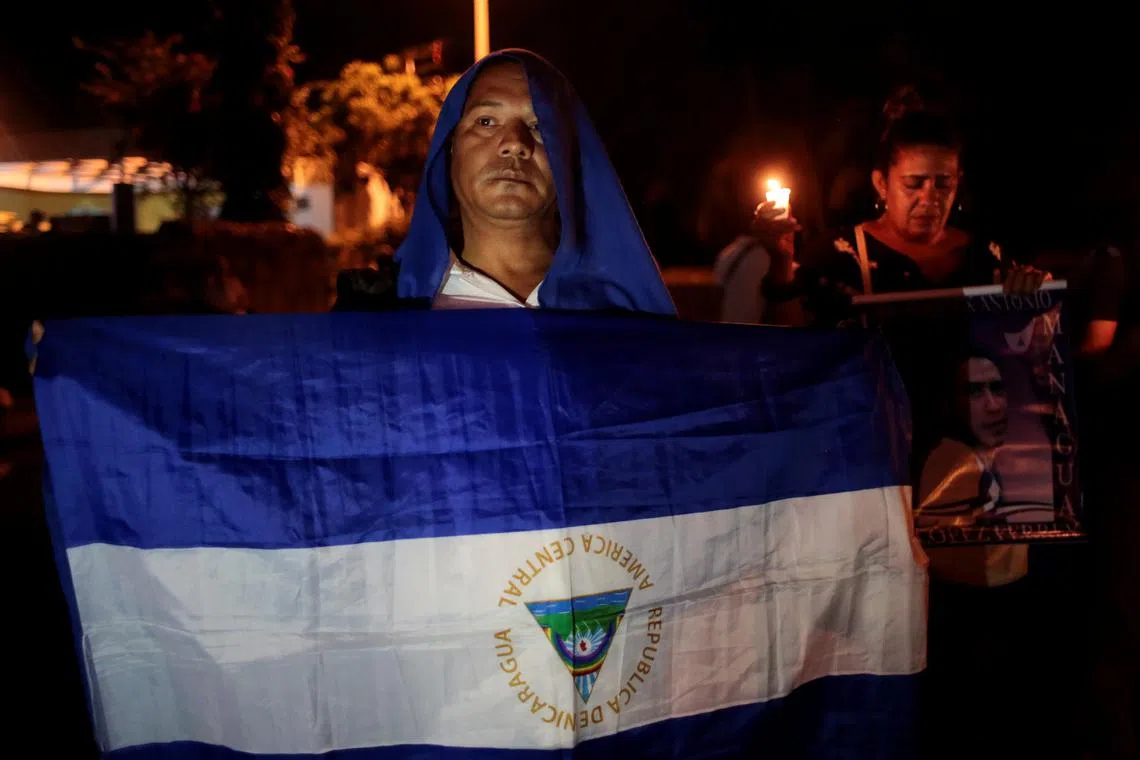 A demonstrator holds a national flag during a candlelight vigil protest for the political prisoners in Managua , Nicaragua, on October 3, 2019.REUTERS/Oswaldo Rivas/File Photo
