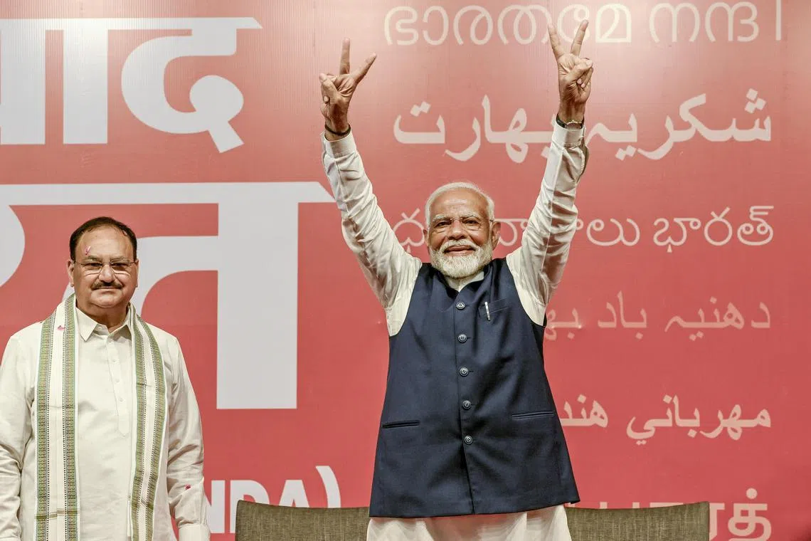  Prime Minister Narendra Modi makes a victory sign to supporters at the Bharatiya Janata Party headquarters after the results of the general elections in New Delhi on June 4.