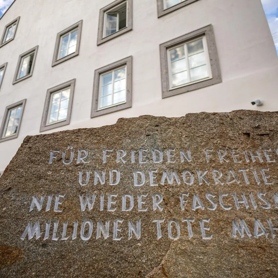 A memorial stone against war and fascism stands in front of the building where Adolf Hitler was born in 1889.