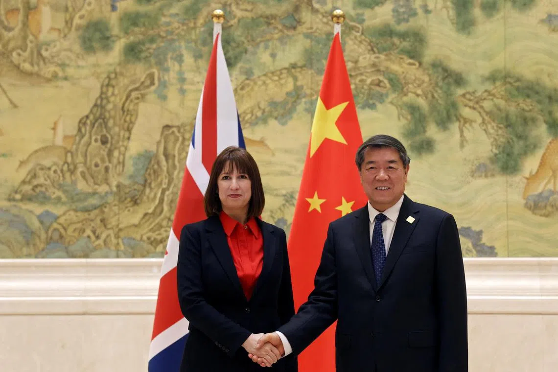Chinese Vice-Premier He Lifeng (right) and Britain's Chancellor of the Exchequer Rachel Reeves (left) shake hands before the China-UK Financial Services Summit.
