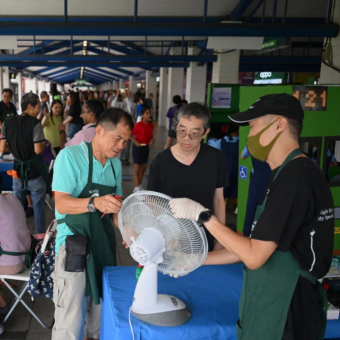 Mr Richard Lee (second from right) learning from Repair Kopitiam volunteers Edmund Ho (right) and Wong Tuan Wah at the repair clinic on Oct 26.