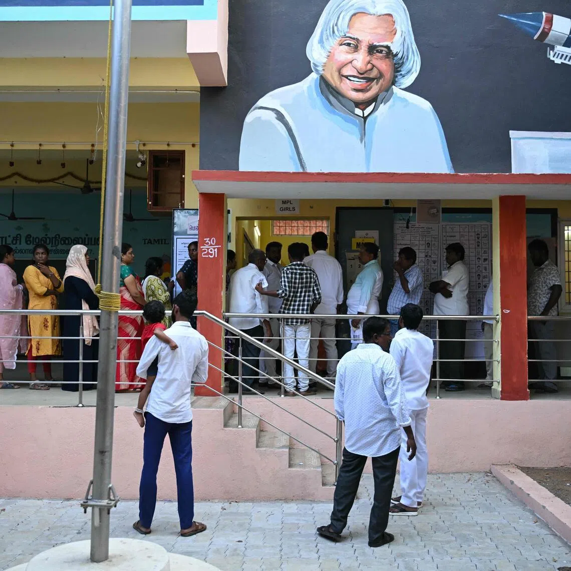 Voters queue to cast their vote outside a polling station during the 2026 Tamil Nadu Legislative Assembly elections in Chennai on April 23.