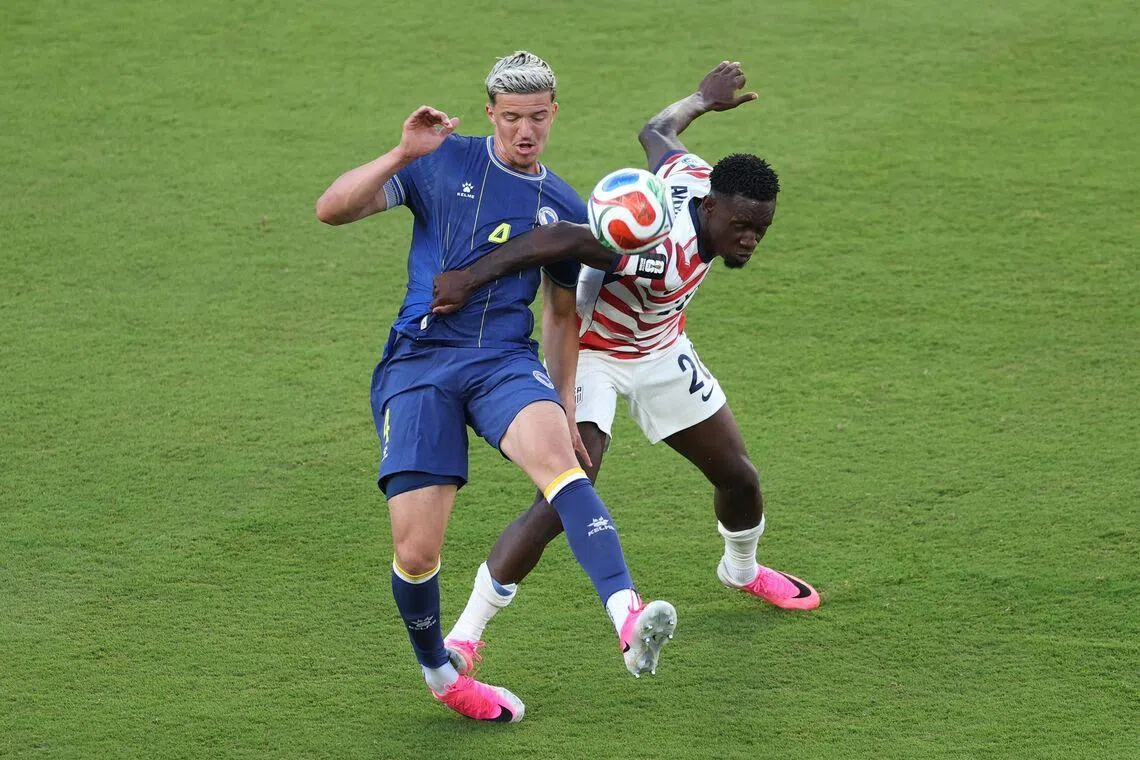 USA’s Folarin Balogun (right) was sent off after being judged to have stamped on the back of Bosnia and Herzegovina defender Tarik Muharemovic’s foot.