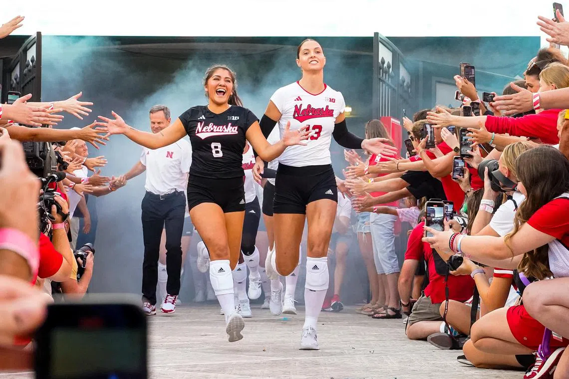 Nebraska Cornhuskers's Lexi Rodriguez and Merritt Beason run out of the tunnel before the match against the Omaha Mavericks at Memorial Stadium.