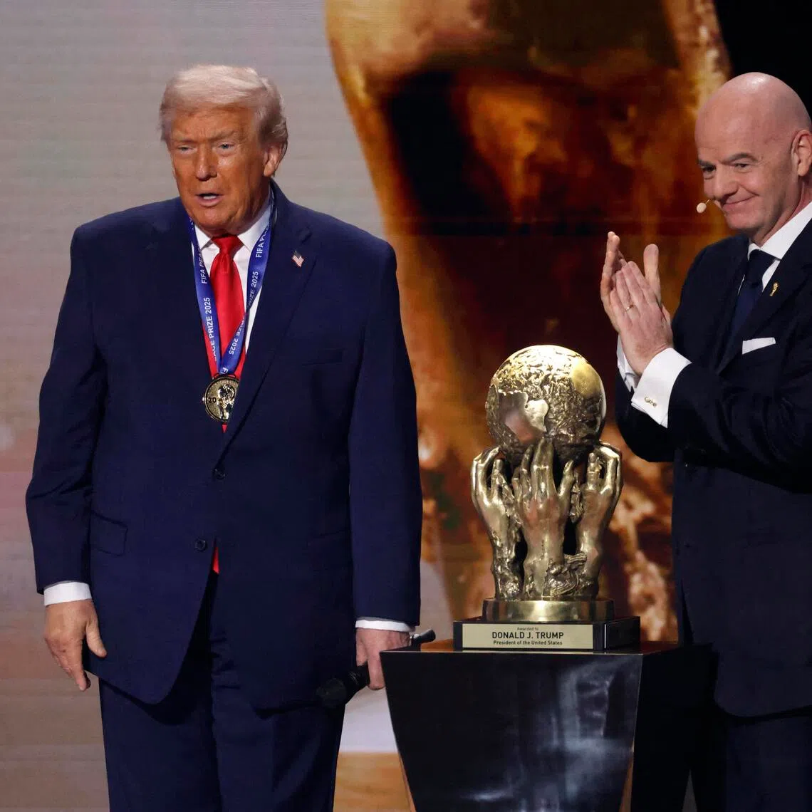 FIFA president Gianni Infantino presents United States President Donald Trump with the FIFA Peace Prize during the 2026 World Cup draw.