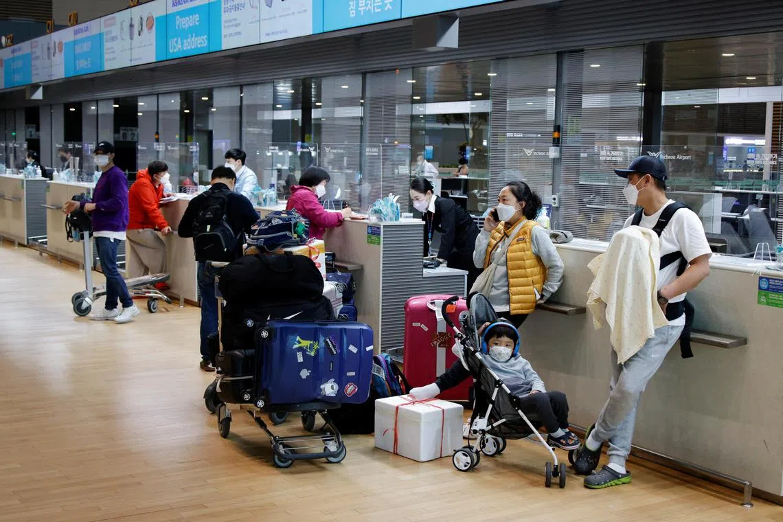 People wearing face masks to protect against Covid-19 at Incheon airport in South Korea. Pressure is building on governments to lift the indoor mask mandate.