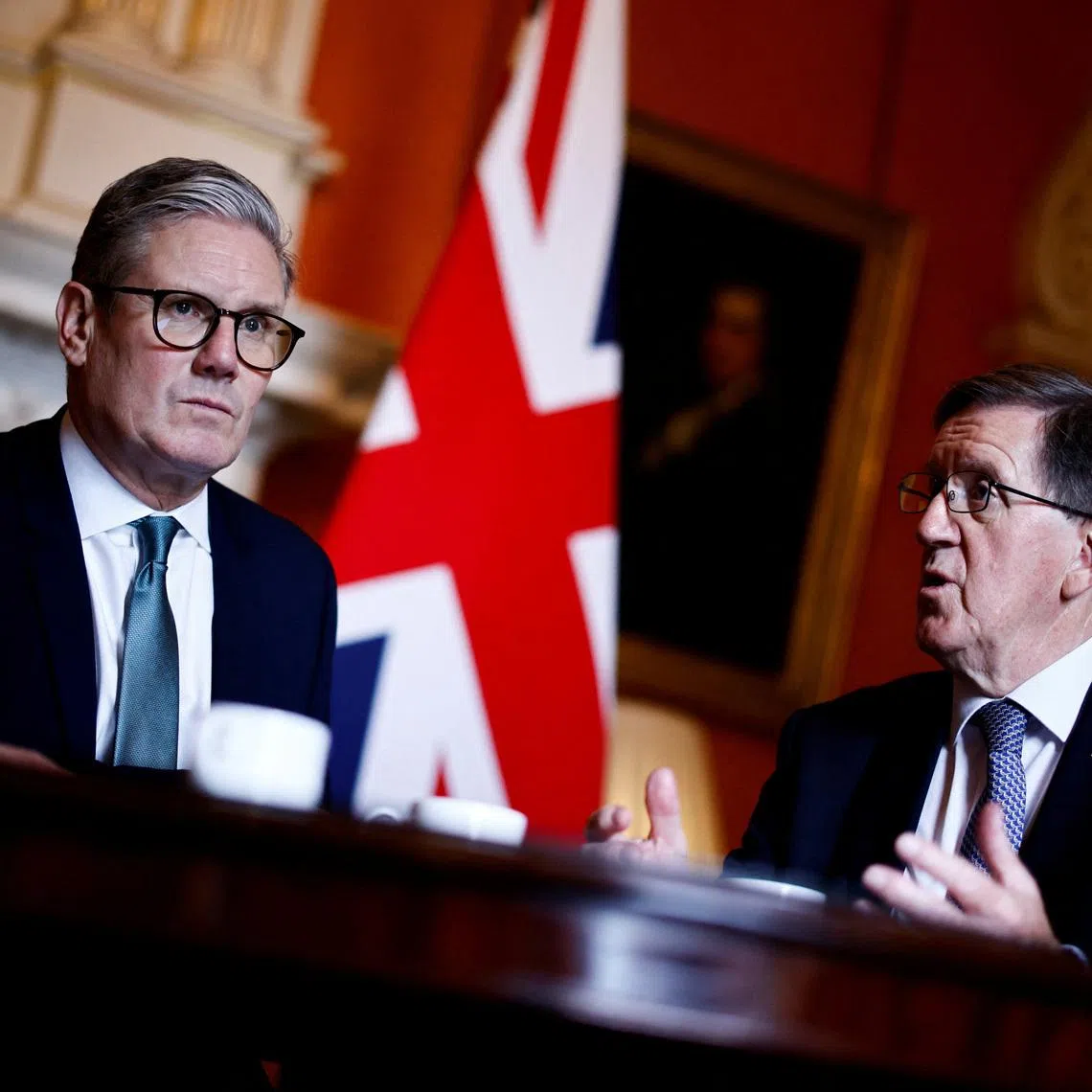 FILE PHOTO: Britain's Prime Minister Keir Starmer (L) listens to Member of the House of Lords George Robertson (R) during a joint meeting with Britain's Defence Secretary John Healey (unseen) at 10 Downing Street, in London, on July 16, 2024. BENJAMIN CREMEL/Pool via REUTERS/File Photo