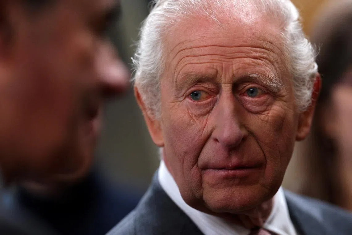 Britain's King Charles meets members of the local community with during a visit to The Market Hall in St Austell, Britain, March 24, 2026.  ADRIAN DENNIS/Pool via REUTERS