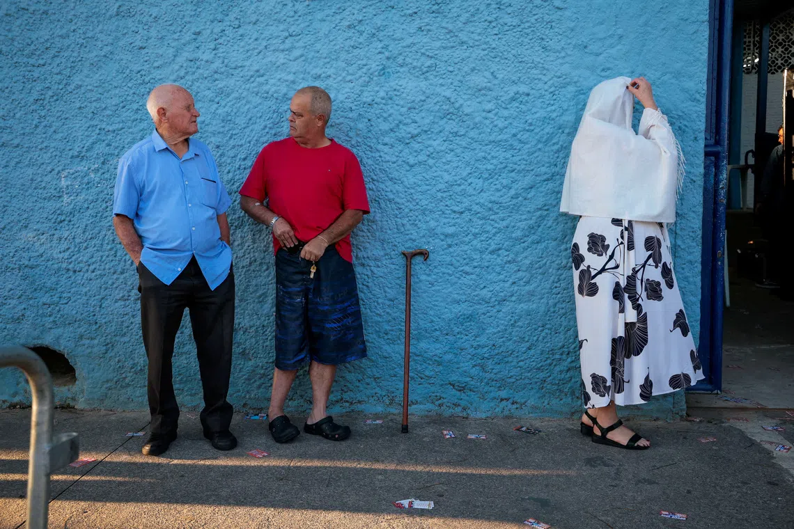People gather in line outside a polling station during the general election in Sao Bernardo do Campo, Brazil, on Oct 4.