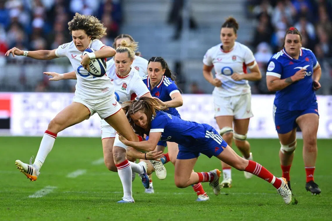 England's full-back Ellie Kildunne is tackled by France's scrum-half Pauline Bourdon Sansus as she runs with the ball in the Women's Six Nations international rugby union match at the Stade Atlantique in Bordeaux on May 17, 2026.