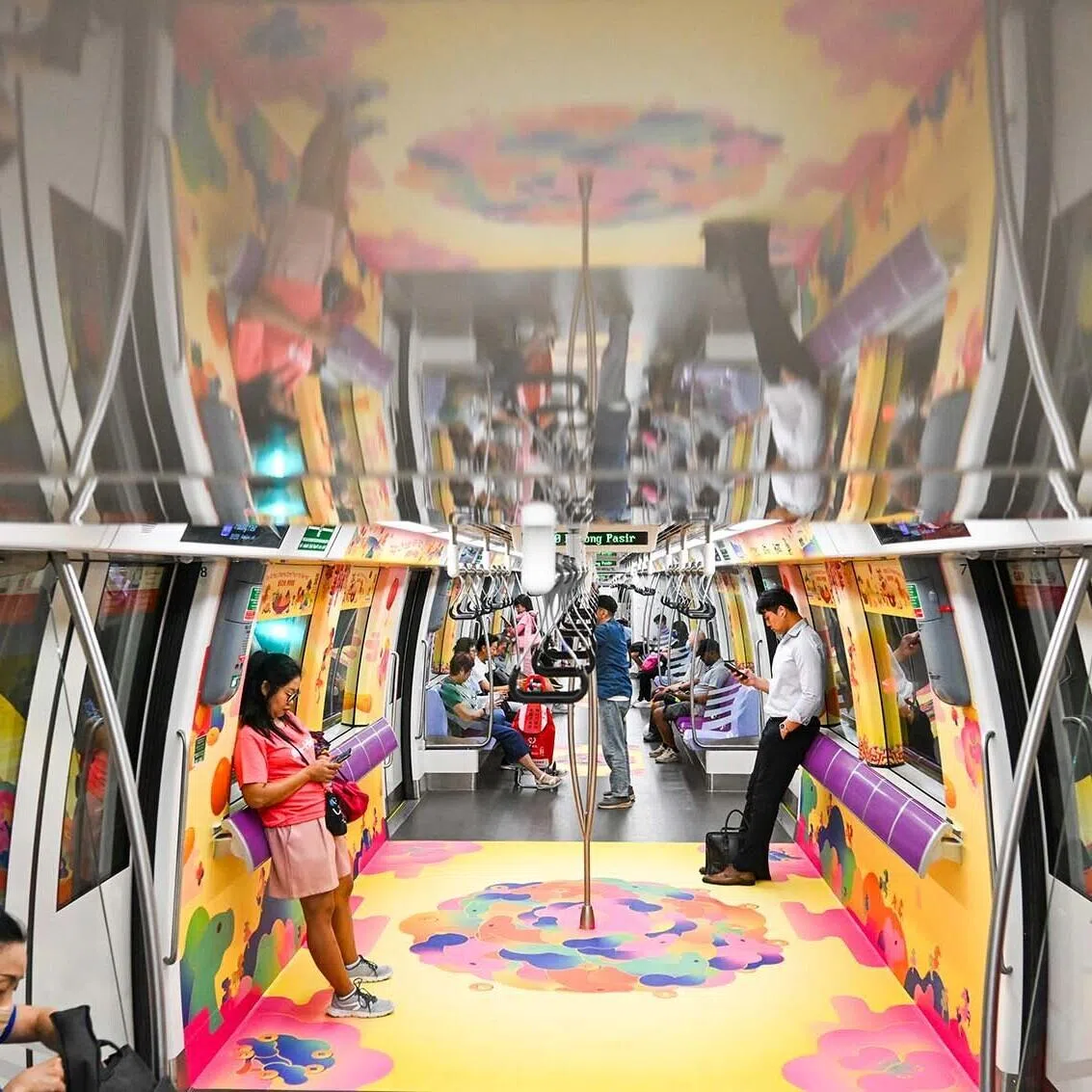 Commuters in Singapore on a Chinese New Year themed train with designs inspired by the Year of the Horse, on Jan 27, 2027. 
