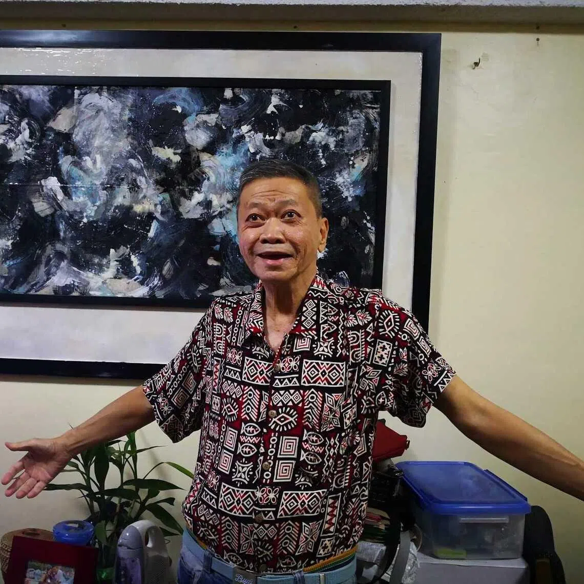Lim Hock Ann, aka Halim, with his abstract painting. 