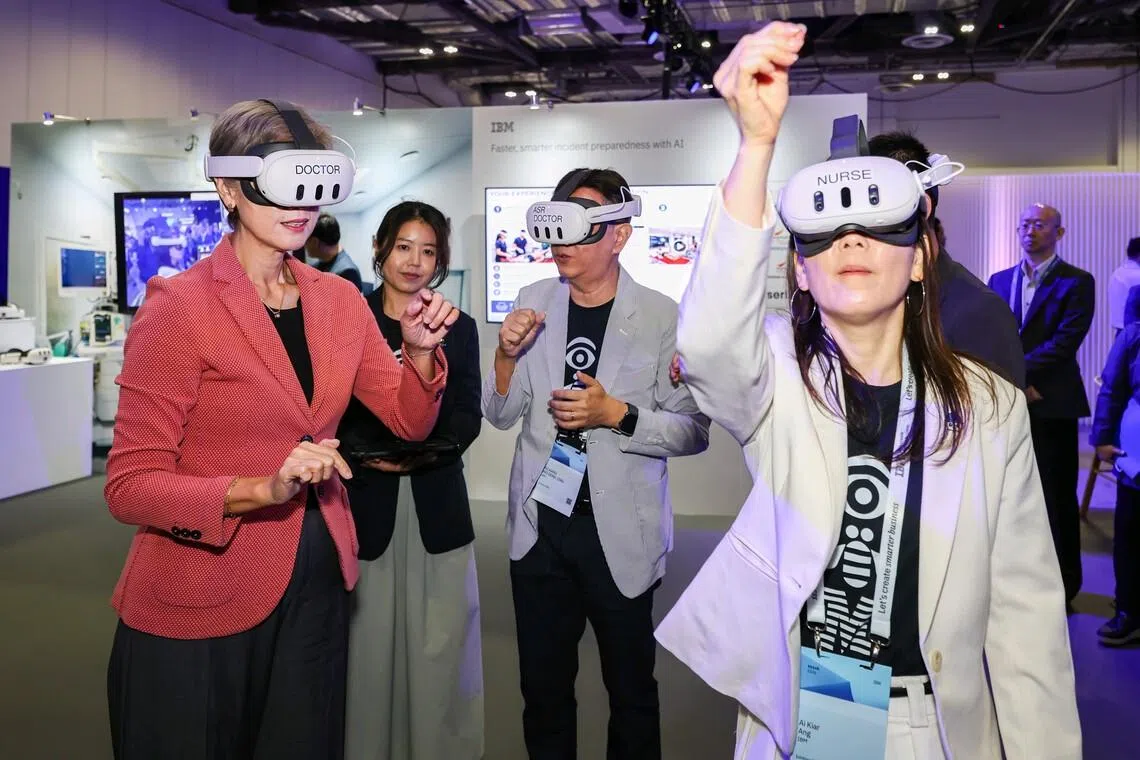 (From left) Minister for Digital Development and Information Josephine Teo, guided by IBM cognitive solution developer Richard Wo and IBM senior data scientist Ang Ai Kiar, trying IBM’s immersive mixed reality training solution, developed with Changi General Hospital, at the IBM Think Singapore conference on July 21.
