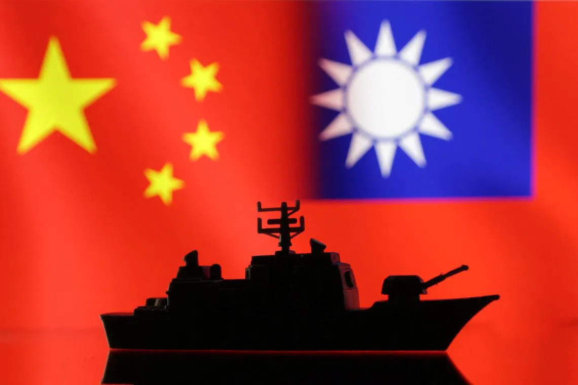 A Navy miniature is seen in front of displayed Chinese and Taiwanese flags in this illustration taken, April 11, 2023. REUTERS/Dado Ruvic/Illustration/File Photo