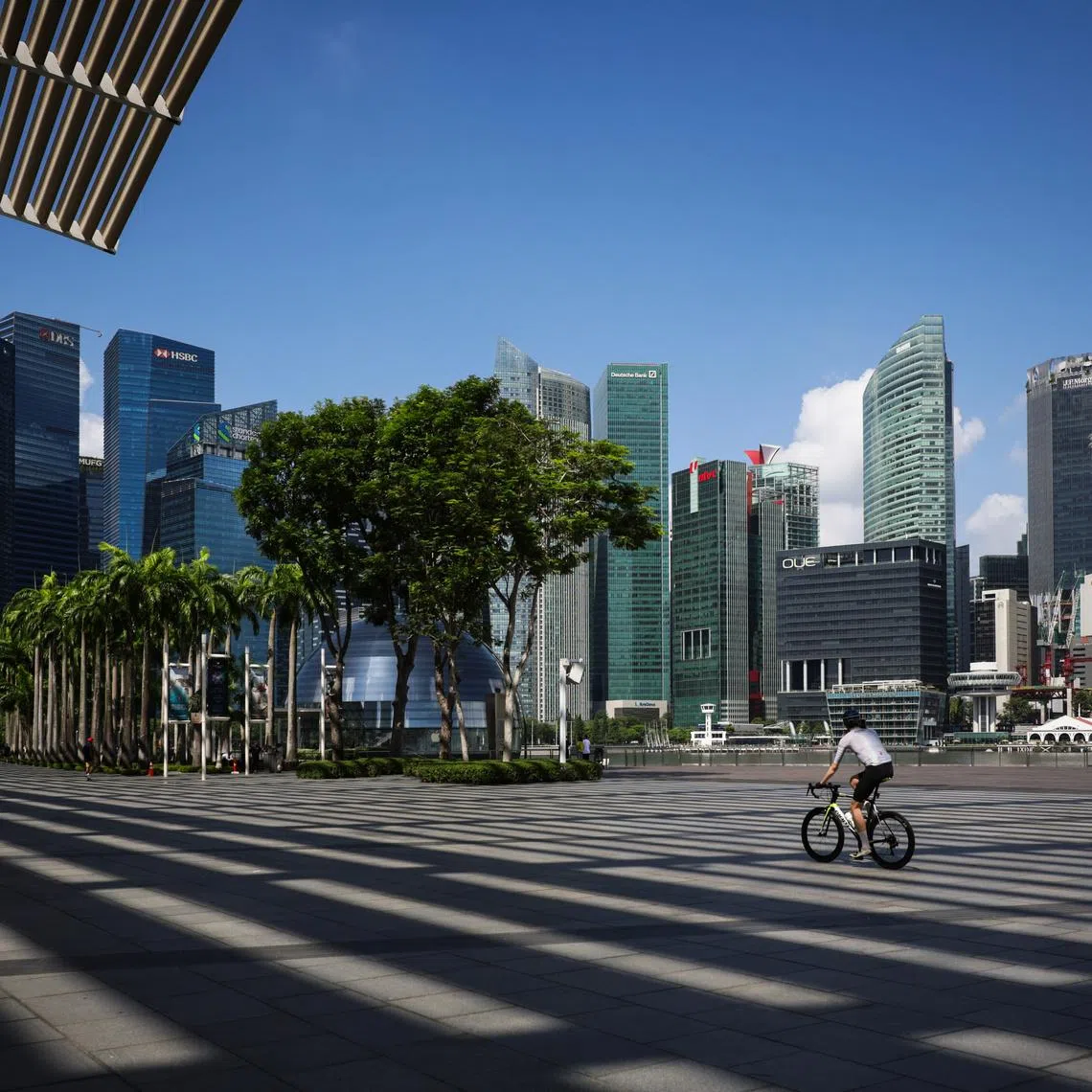 Generic photo of a cyclist rides across an open plaza at The Shoppes at Marina Bay Sands with the financial district skyline in the background on Mar 18, 2026. Can use for stories on: urban mobility, cycling culture, car-lite initiatives, public spaces, city planning, business district activity, lifestyle, sustainable transport, outdoor recreation, Singapore, Central Business District, CBD, skyline, cityscape, cyclist, cycling, bicycle, urban mobility, car-lite, public space, plaza, promenade, financial district, office buildings, architecture, lifestyle, transport, sustainability, outdoor, Southeast Asia, economy