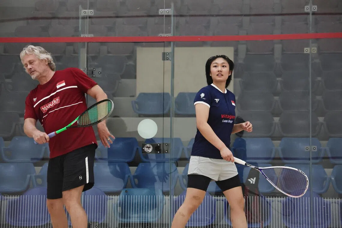 Cassandra Ong (right) practicing with then-national head coach Jamie Hickox at the Kallang Squash Centre ahead of the 2024 Singapore Squash Open.