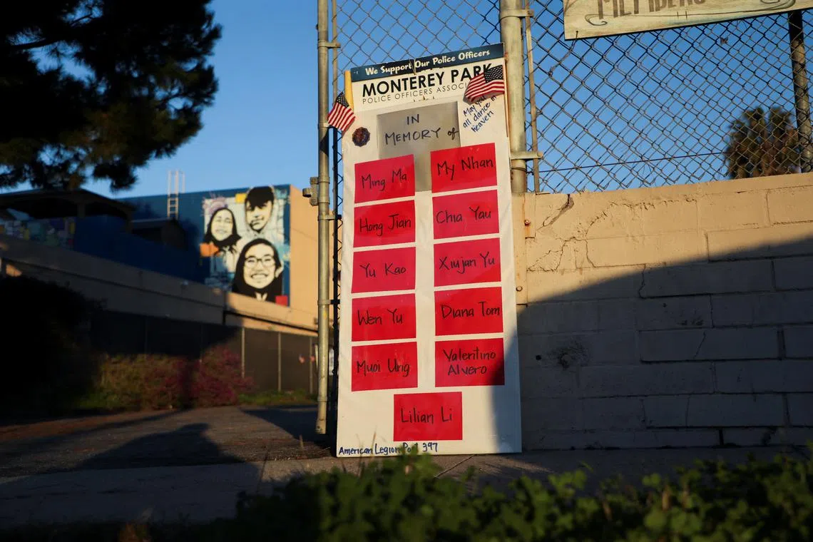 The names of the eleven people killed are written on a sign, as people gather for a candlelight vigil after a mass shooting during Chinese Lunar New Year celebrations in Monterey Park, California, U.S. Jan 24, 2023. 