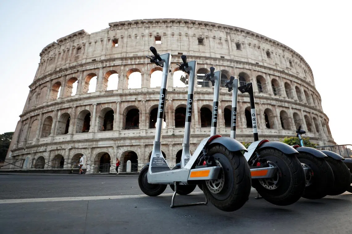 FILE PHOTO: Electric scooters are parked near the Colosseum in Rome, Italy, September 18, 2020. Picture taken September 18, 2020. REUTERS/Guglielmo Mangiapane/File Photo
