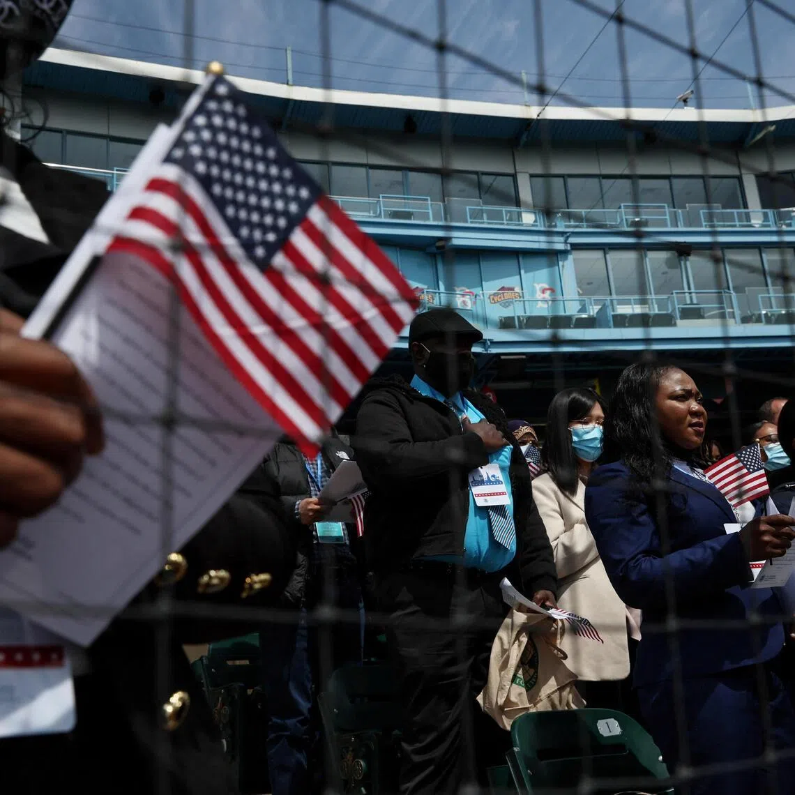 Citizen candidates attend a US Citizenship and Immigration Services (USCIS) naturalisation ceremony.