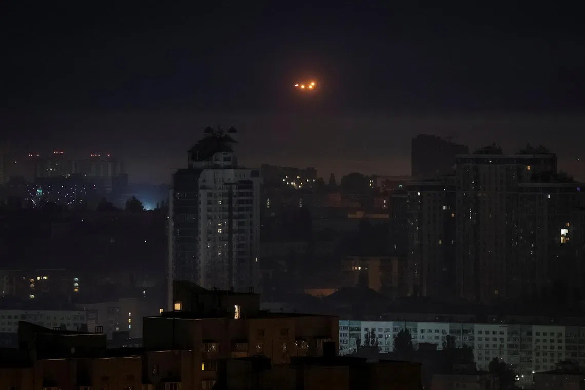 Explosions are seen in the Kyiv night sky as Ukrainian servicemen fire towards drones during a Russian drone strike on May 26. 