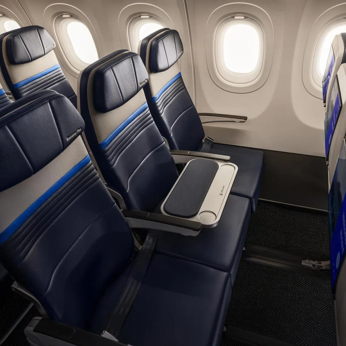 In an undated image provided by United Airlines, an example of a row with a shared table in the middle seat on a United Airlines flight.