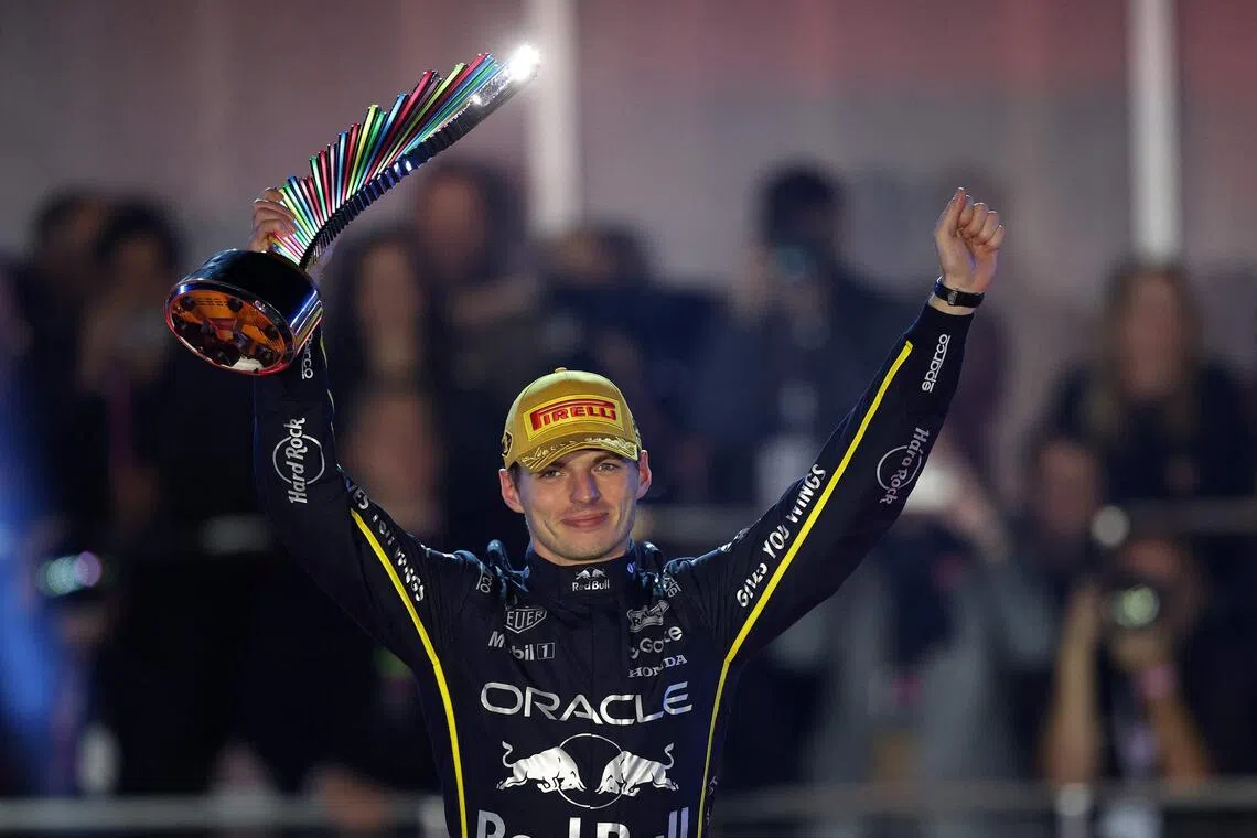 Red Bull's Max Verstappen lifting his trophy in triumph after winning the Las Vegas Grand Prix on Nov 22.