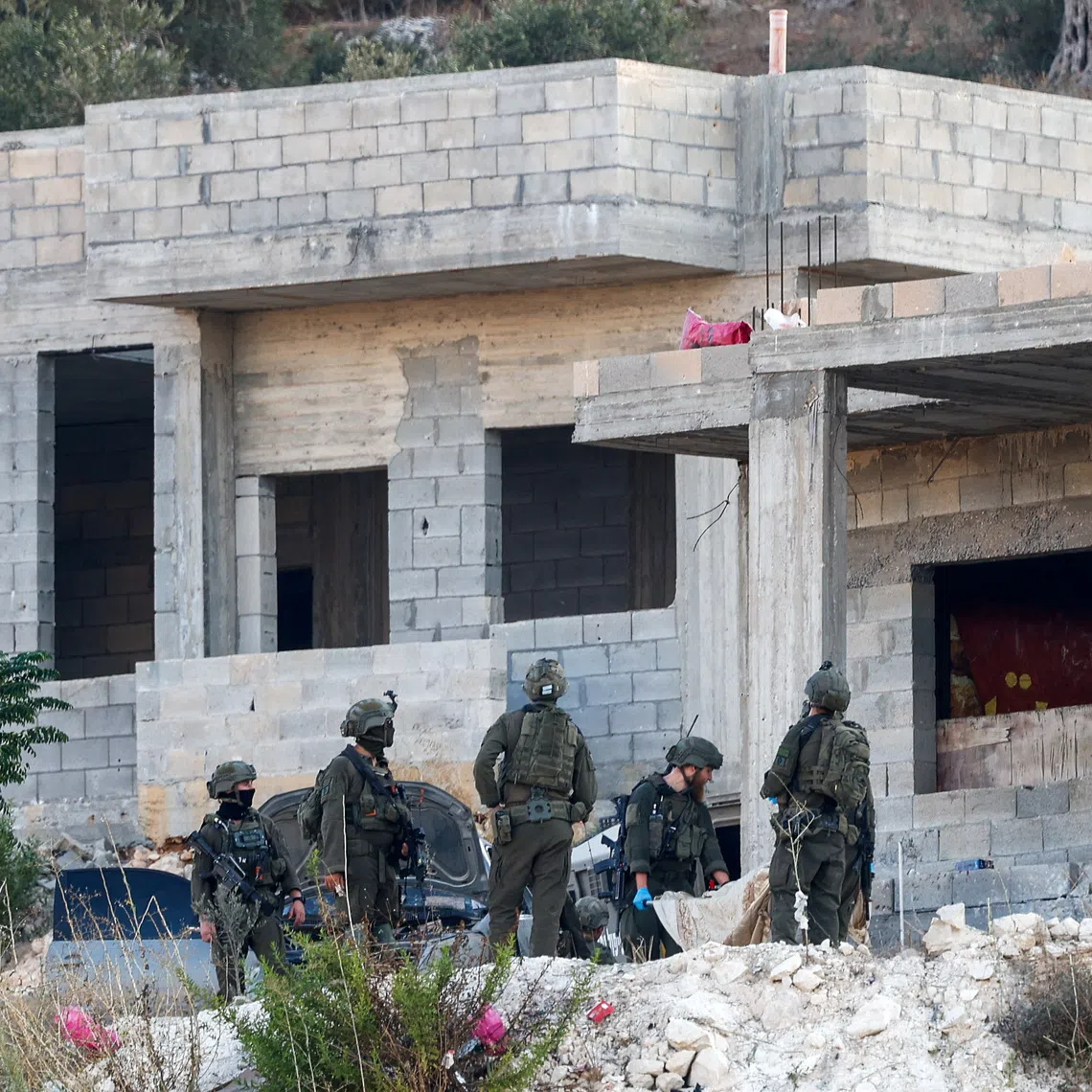 Israeli military forces carry the body of a Palestinian, following an Israeli military airstrike, in Jenin, in the Israeli-occupied West Bank, August 28, 2026. REUTERS/Mohammed Torokman