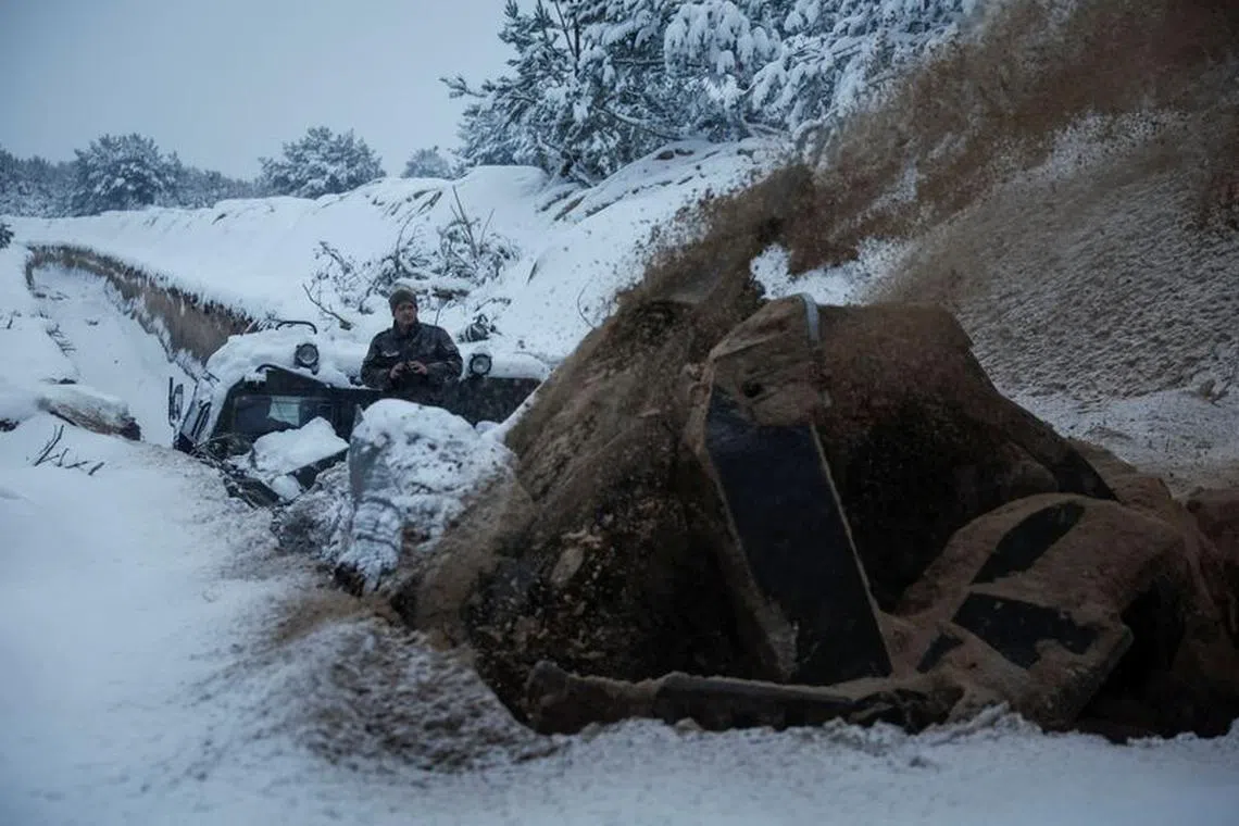 A Ukrainian serviceman digs an anti tank ditch with a MDK-3 military engineering vehicle, amid Russia's attack on Ukraine, near Belarus border in Chornobyl exclusion zone, Ukraine December 14, 2023. REUTERS/Gleb Garanich/File Photo