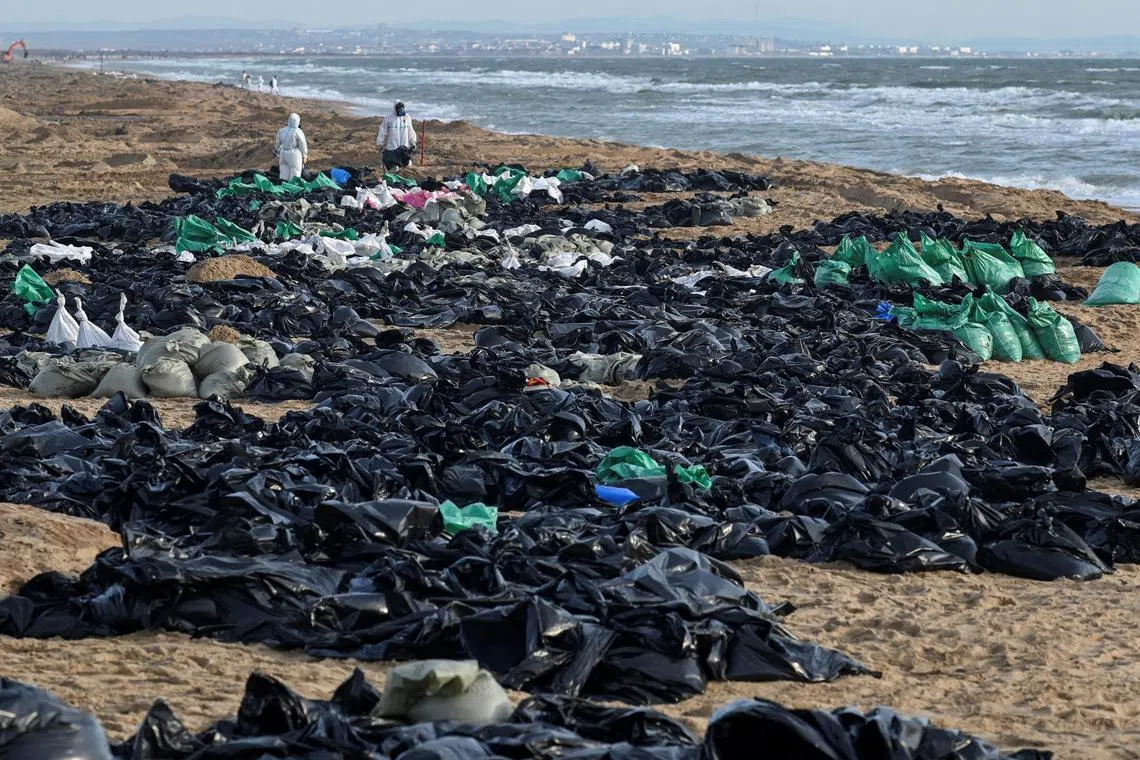 Volunteers cleaning up spilled oil along the coastline after two tankers were damaged in a storm in the Kerch Strait. The incident took place near the settlement of Blagoveshchenskaya, close to the Black Sea resort of Anapa in the Krasnodar region, Russia, on Dec 21, 2024.
