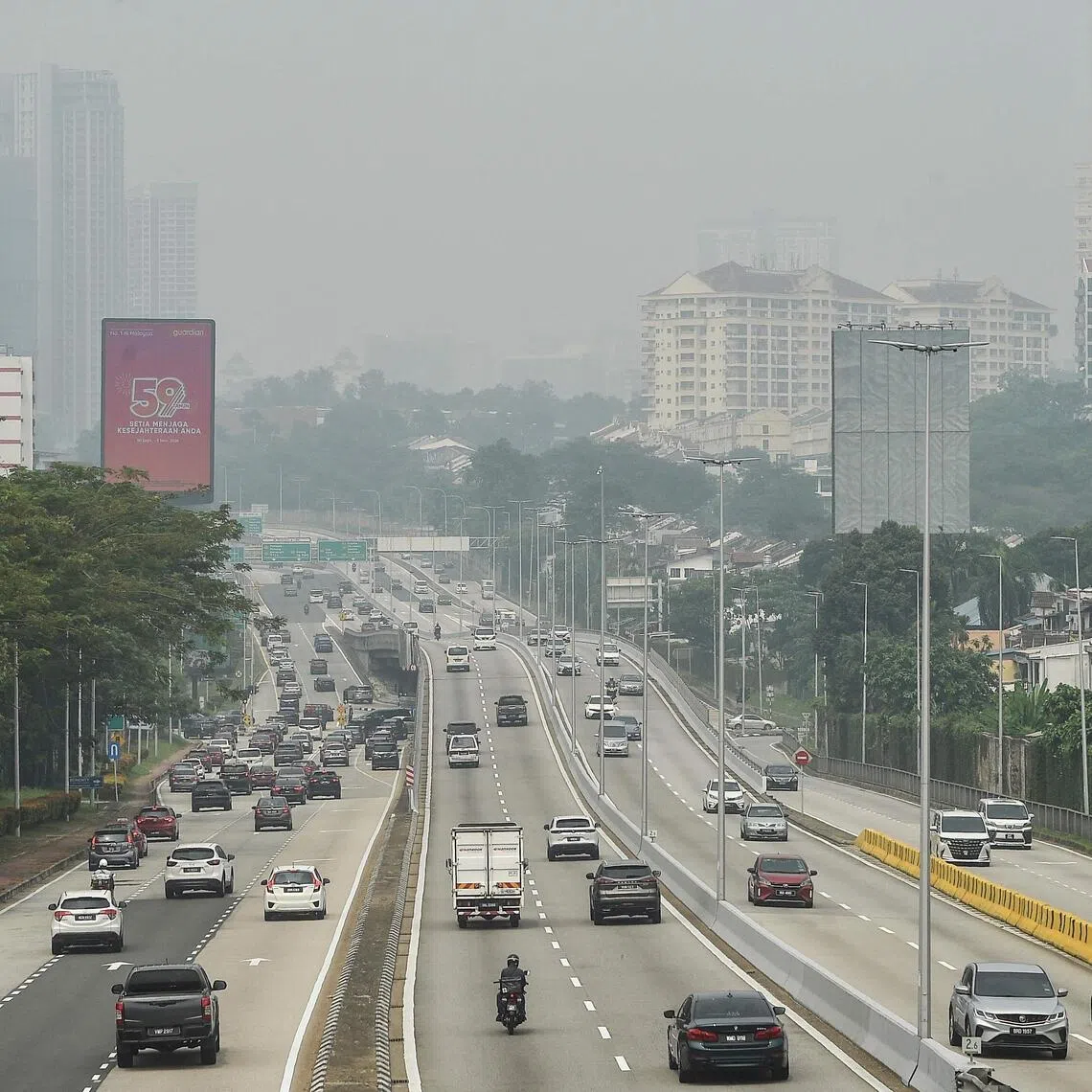 Traffic move along a highway amid hazy condition in Kuala Lumpur on Oct 9.