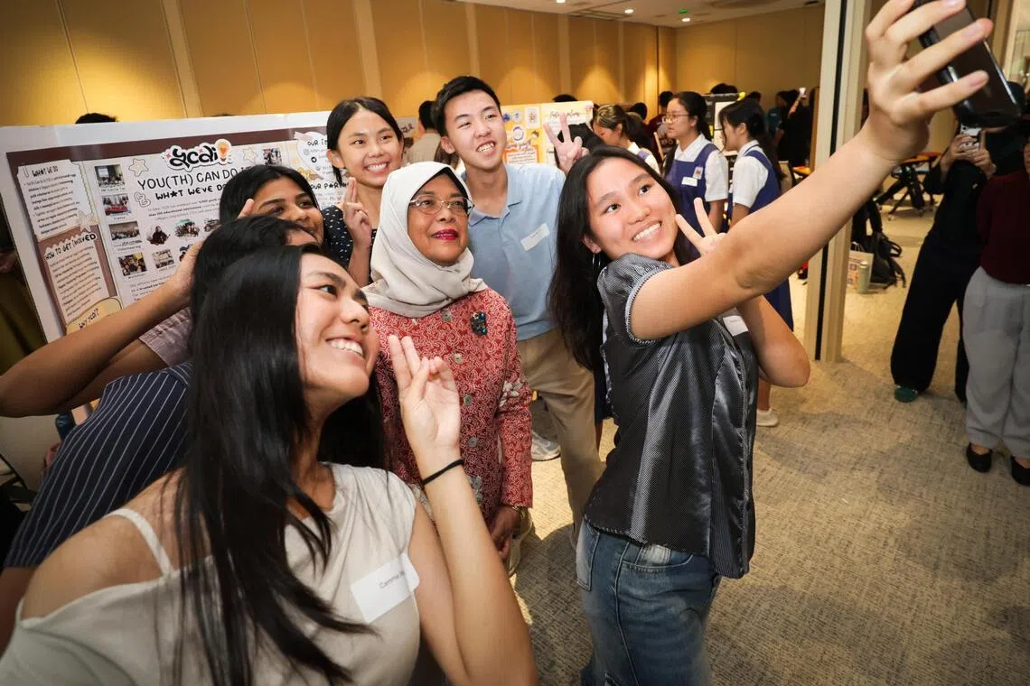 Former president of Singapore Halimah Yacob, who is the Chancellor of the Singapore University of Social Sciences, posing for a wefie at the Festival of Deeds on June 5.