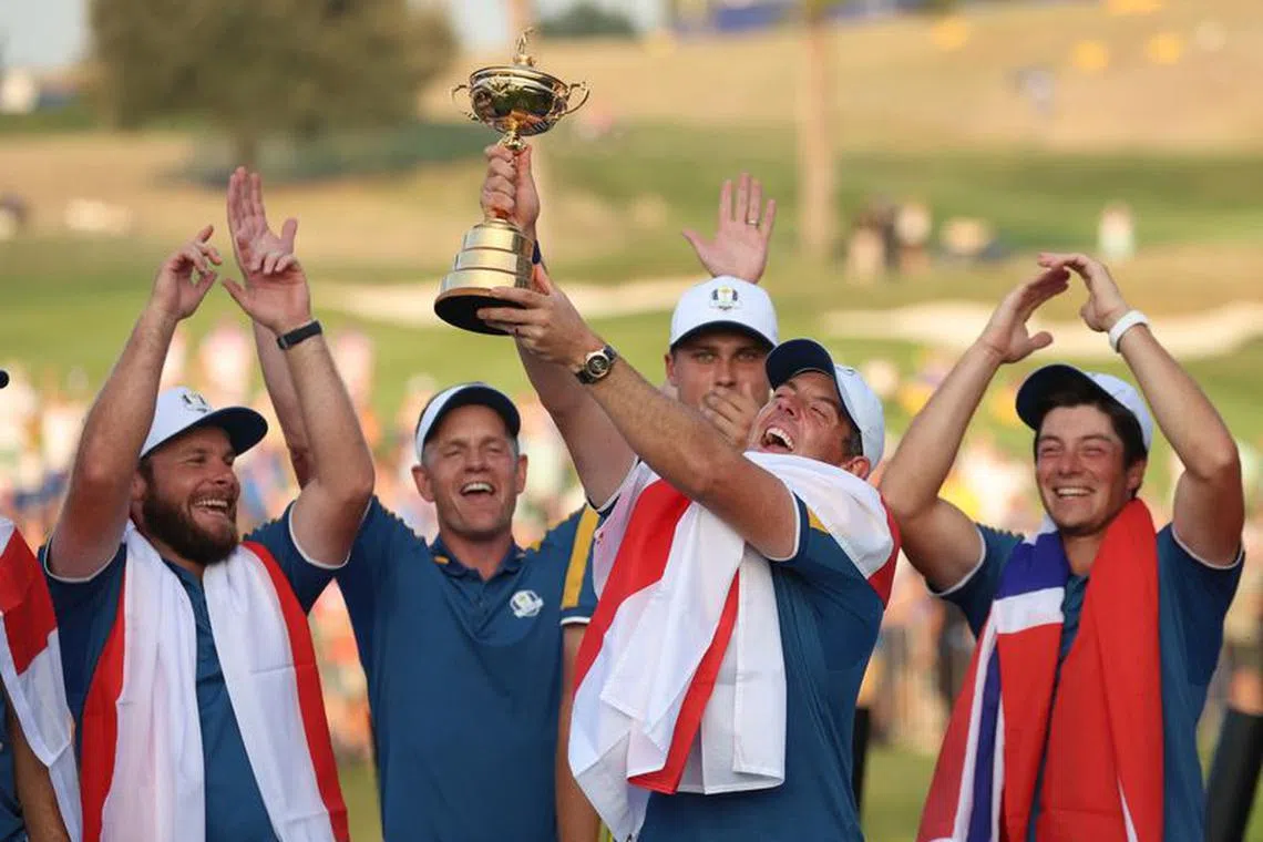 Golf - The 2023 Ryder Cup - Marco Simone Golf &amp; Country Club, Rome, Italy - October 1, 2023 Team Europe's Rory McIlroy celebrates with the trophy and teammates during the presentation after winning the Ryder Cup REUTERS/Phil Noble
