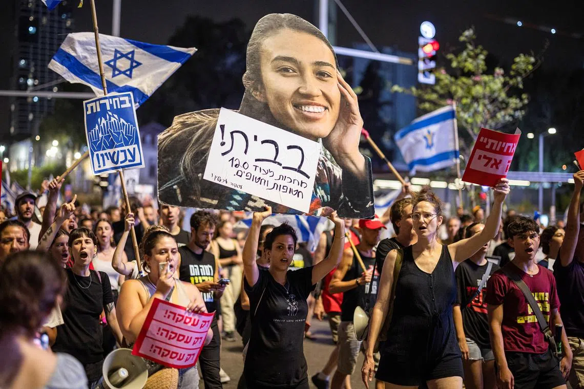 A protester holds up an image of Noa Argamani, a recently rescued hostage, during a protest against Israeli Prime Minister Benjamin Netanyahu's government and to call for the release of hostages amid the ongoing conflict between Israel and Hamas, in Tel Aviv, Israel, June 8, 2024. REUTERS/Marko Djurica